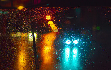 raindrops on car window colorful lights background