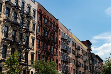 Obraz premium Row of Colorful Old Residential Buildings in the East Village of New York City with Fire Escapes
