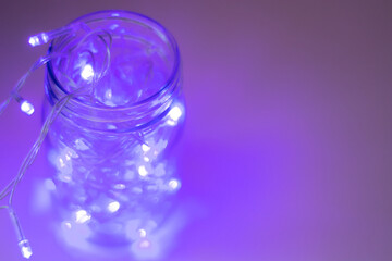 Lights inside the glass jar, colorful light glowing in the dark inside the jar. selective focus
