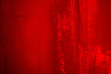 Closeup of painted wall in red with brush strokes.