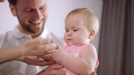 Mother and father enjoy playing with child. Joyful family enjoy togetherness