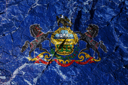 National flag of Pennsylvania, USA on blue with seal: ship, plow and sheaves of wheat; on coat of arms - an eagle; at edges of shield are two black horses. Rock graffiti of climbers during the ascent.
