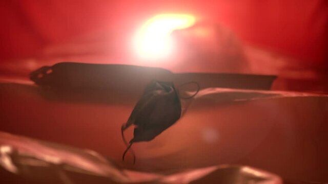 Slowmo: Surgical Mask And Trash Floating In A Sea Made Of Plastic During Sunset 