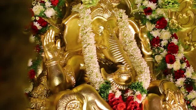 Hindu God Lord Ganesha in full glory adorned with flowers for a Pooja