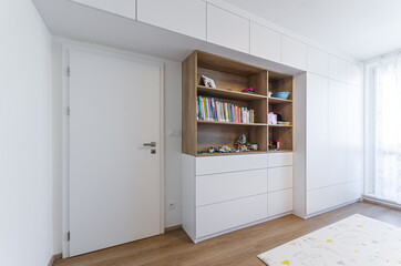 Cabinet shelf wardrobe in Children's room with toys and books - obrazy, fototapety, plakaty