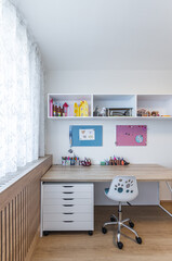 Children's room with table, wardrobe and toys