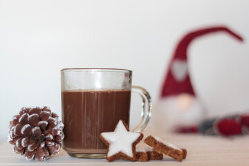 Hot chocolate and cookies with christmas gnome on the background. Winter holiday concept