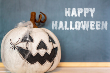 Scary pumpkin with spider web and spider. With Happy Halloween text