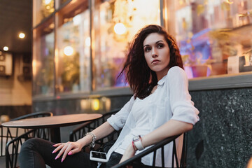 Woman sitting on the terrace in the summer evening.