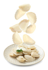 Many tasty dumplings falling on white background