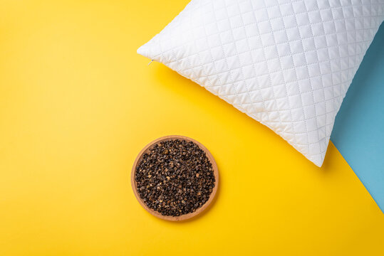 A Plate Of Buckwheat Husks And A White Pillow