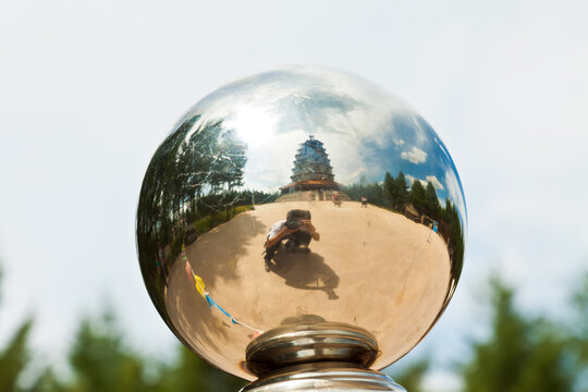 photographer and pagoda in a metal ball