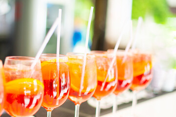 Photo of sweet red cocktails on bar during summer time