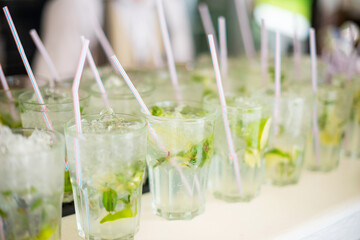 Close up photo of fresh mojito cocktails on bar table during sum