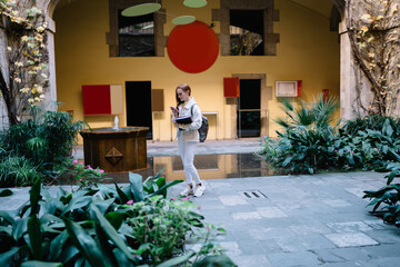Young lady browsing smartphone in garden