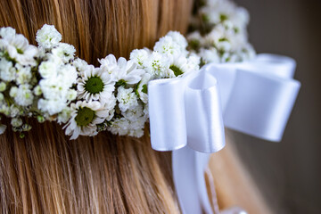 Female hair with crown of flower. Holy commiunon, wedding flowers crown. Close up macro