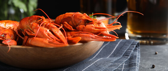 Delicious red boiled crayfishes on table, closeup. Banner design