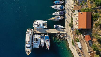 Aerial drone photo of picturesque beautiful seaside village of Kioni a safe anchorage for yachts...