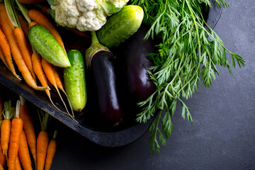 set of vegetables on a dark table, carrots, cabbage, cucumber, eggplant