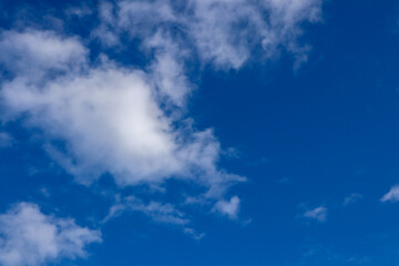 Fototapeta na wymiar Beautiful dark blue sky with white snowy clouds