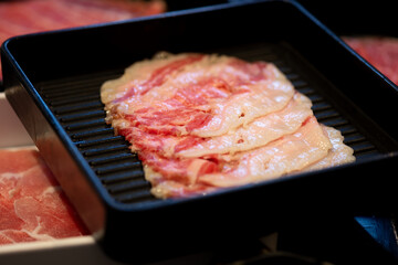 Beef slice on black tray for hot pot or grill (barbecue or yakiniku).