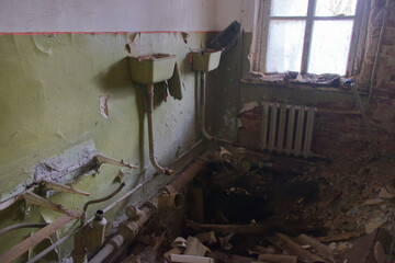 A collapsed floor in a kindergarten toilet in the Chernobyl exclusion zone. Abandoned, dilapidated building.