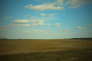 Fototapeta premium Beautiful cloudy sky over farmland. Spring landscape.