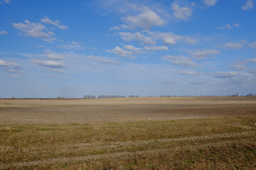 Fototapeta na wymiar Beautiful cloudy sky over farmland. Spring landscape.