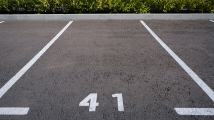 Close-up of a white paint number marking in a parking lot. Empty parking lot, Parking lot with white mark, Open parking in public park. Number 41.