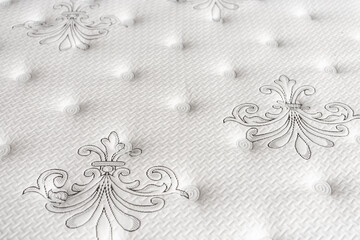 Choosing mattress. Close-up white mattress in furniture store. Copy space