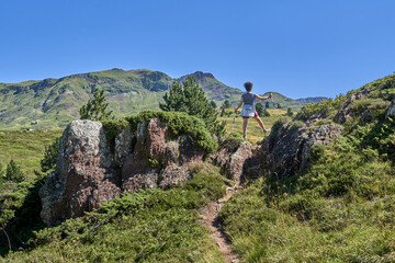 Woman walking through a mountain landscape