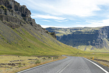 Road in Iceland with mountains and snow in the background