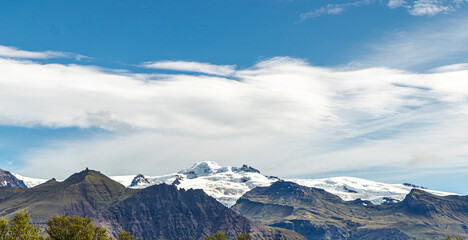 Some snowy mountains in Iceland with a blue sky in the background