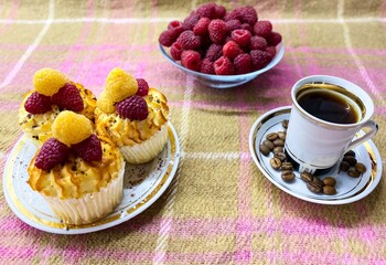 Freshly baked curd muffins with raspberries and a cup of aromatic invigorating coffee.The concept of homemade baking, proper nutrition, agriculture.