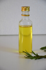 Fresh organic rosemary with essential oil over white background