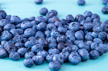 close up of Ripe bluberries on blue Background. Dried Delicious Blueberries for Superfood - Healthy ingredients for muesli, cereal.