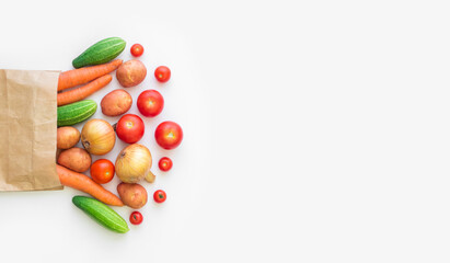 Fresh farm vegetarian and vegan vegetables in paper bag on white background. Healthy food supermarket banner. Zero waste concept. Copy space