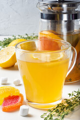 Sweet tea made from citrus fruits, berries, herbs with juicy fruit marmalades. Against the background of an unsurpassed author's teapot of a famous master from China.