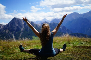 Happy girl practice yoga and meditation outdoor at Plan de Corones on a summer day, Sudtirol, Trentino Alto Adige, Italy