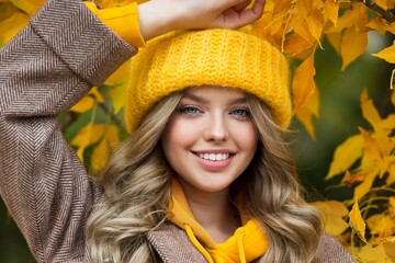 Beautiful woman walking outdoors in autumn. Smiling woman collects yellow leaves in autumn. Young woman enjoying autumn weather.