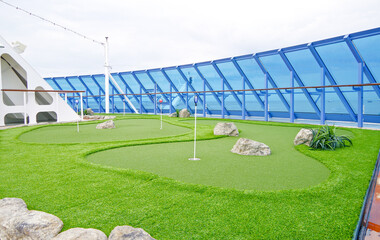 Shuffleboard and mini golf putting green field onboard luxury cruise ship or cruiseship liner