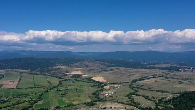 Farm fields and mountains on the background, summer landscape, France.