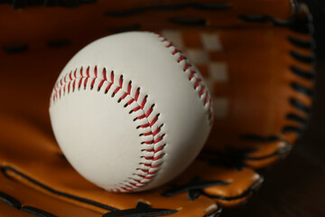 Professional leather baseball ball and glove, closeup