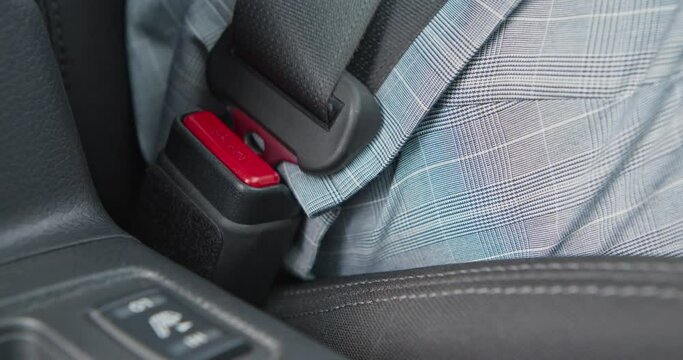 Driver wearing safety belt before driving car