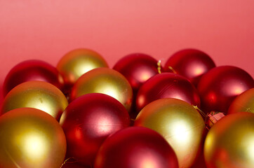 Lots of red and gold Christmas balls on a red background