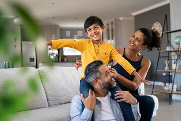 Happy son playing with parents at home