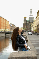 Fototapeta na wymiar Young woman walking along the streets of a big city.