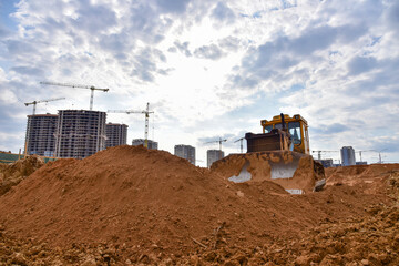 Track-type dozer during of large construction jobs at building site. Bulldozer on road work. Land clearing, grading, pool excavation, utility trenching, utility trenching. Earth-moving equipment.