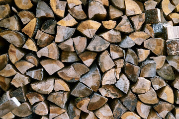 Defocused background with dry firewood. Close up.