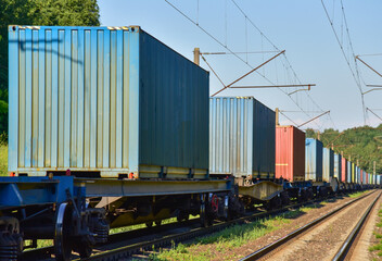 Fototapeta na wymiar Cargo Containers Transportation On Freight Train By Railway. Intermodal Container On Train Car. Rail Freight Shipping Logistics Concept. Import - export goods from Сhina. Motion, Out of focus